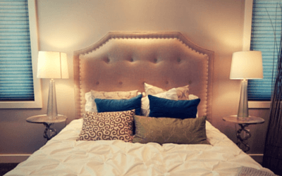 Picture of a bed with pillows in a bedroom.